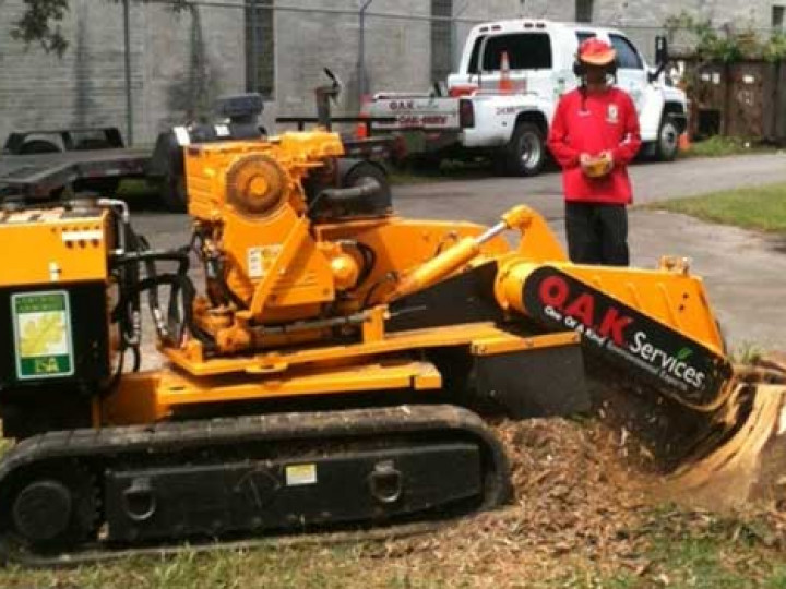 Professional wood chipping equipment processing tree debris into mulch during residential debris hauling service.